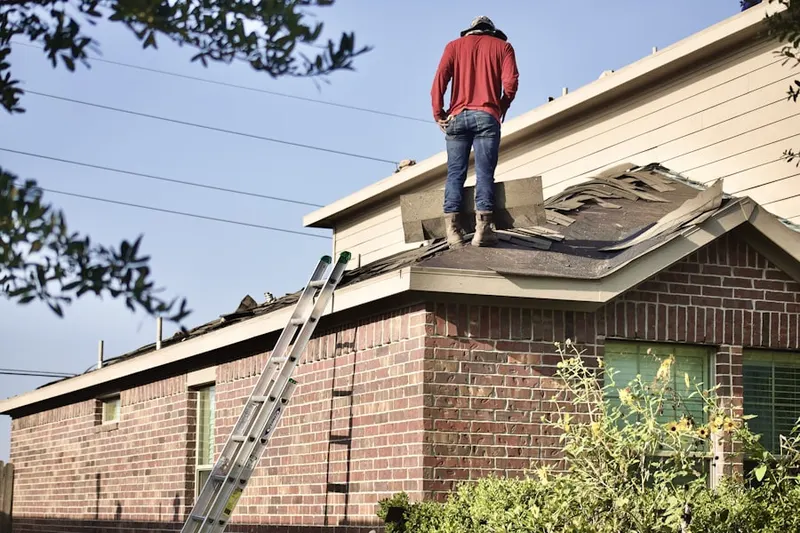 Professional roofer working on a residential roof in Del Rio